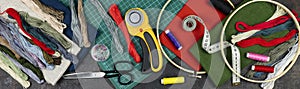 Quilting, embroidery and sewing tools on the dark background. patchwork knife, scissors, lined cutting mat, self-locking, threads photo