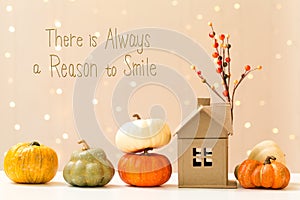 There is always a reason to smile message with pumpkins with a h