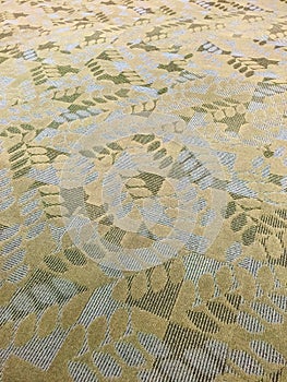 Contemporary textured gold, white and green  carpeting. photo