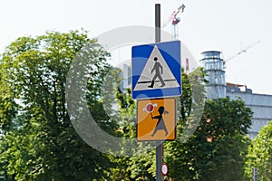 There is a road sign near the road - a pedestrian crossing and the sudden appearance of children is possible.