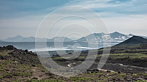 There is scant vegetation on the mountainside, volcanic rocks.