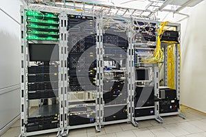 There are several racks with powerful computer equipment in the server room. Computing hardware works in a modern data center. The