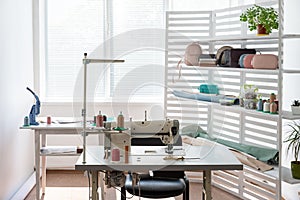 There is sewing equipment in a spacious bright room