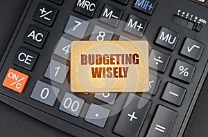 There is a sign on the calculator that says - Budgeting wisely