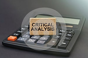 There is a sign on the calculator that says - CRITICAL ANALYSIS