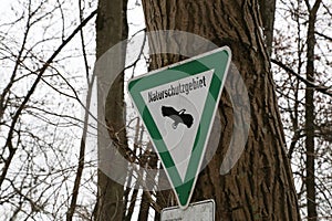 There is a sign on the tree: nature reserve