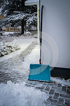 there is a snow shovel on the wall of a house