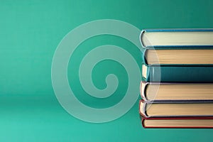 There is a stack of books, and on the top, there is an open book