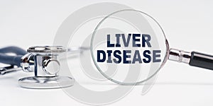 There is a stethoscope on the table, a magnifying glass with the inscription - Liver Disease