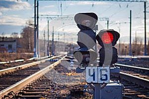 There is a traffic light on the railway for warning of train movement.
