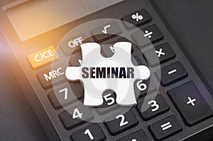 There is a white puzzle on the calculator with the inscription - SEMINAR