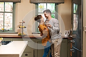 Theres happiness in every move. an affectionate young couple dancing together in their kitchen at home.