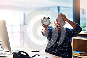 Theres just too much to do with too little time. Portrait of a young designer looking stressed out while holding an