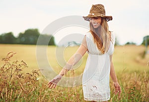Theres a lot of beauty in ordinary things. Cropped shot of a young woman in a wheat field.