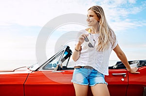 Theres so much more to explore. a happy young woman enjoying a summers road trip.