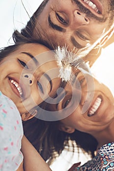 Theres nothing quite like family. Low angle portrait of a happy young family enjoying their day at the beach.