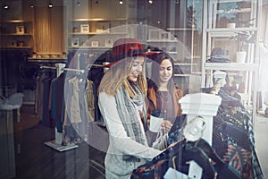 Theres always a reason to shop. two best friends out shopping in a clothing store.