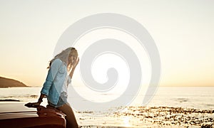 Theres something about summertime that adds that carefree element. a young woman enjoying a road trip along the coast.