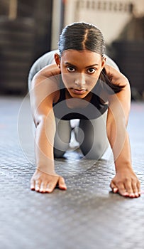 Theres strength in serenity. Portrait of a fit young woman working out in a gym.