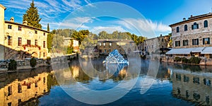 Thermal bath town of Bagno Vignoni, Italy during sunrise. Old thermal baths in the medieval village Bagno Vignoni, Tuscany, Italy