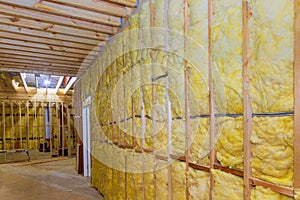 Thermal fiberglass insulation mineral rock wool installation to wall at new construction a home