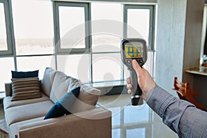 Thermal imaging camera at apartment inspection for finding heating leakage