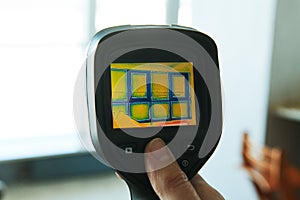 Thermal imaging camera at apartment inspection for finding heating leakage