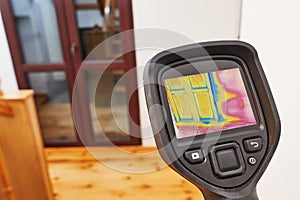 thermal imaging camera inspection balcony window for temperature check and finding heat loss