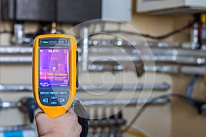 Thermal imaging inspection of heat system with tubes at house