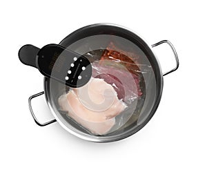 Thermal immersion circulator and meat in pot on white background, top view. Vacuum packing for sous vide cooking
