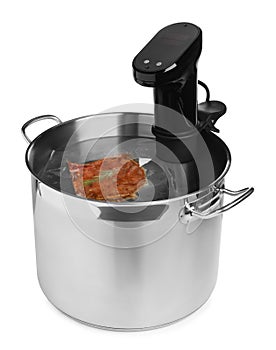 Thermal immersion circulator and meat in pot on white background. Vacuum packing for sous vide cooking