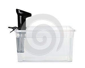 Thermal immersion circulator in plastic container with water isolated on white. Sous vide cooker