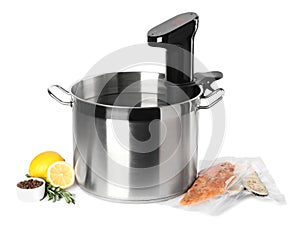 Thermal immersion circulator in pot and ingredients on white background. Sous vide cooking