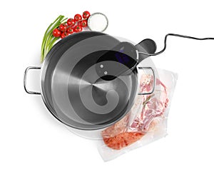 Thermal immersion circulator in pot and ingredients on white background, top view. Sous vide cooking