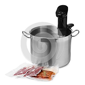 Thermal immersion circulator in pot and meat on white background. Vacuum packing for sous vide cooking