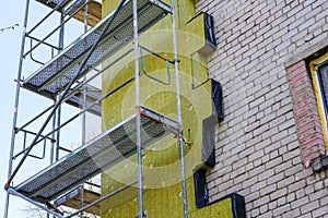 Thermal insulation of the facade of an apartment building with thick mineral rockwool slabs
