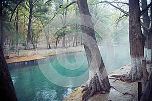 Thermal lagoon under deep sky , Blurred photo of morning fog over a lake in cold autumn weather in half moon san luis potosi