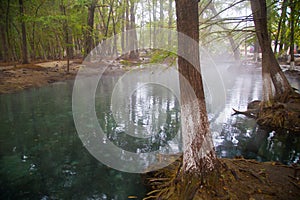 Thermal lagoon under deep sky , Blurred photo of morning fog over a lake in cold autumn weather in half moon san luis potosi