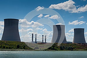 Thermal power plant chimneys near lake