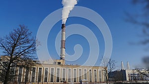 Thermal power plant smokes a chimney into the blue sky