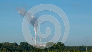 Thermal power plant with smoking chimneys emits dense smoke in the production of electricity