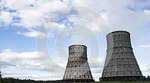 Thermal power station, cogeneration plant, huge cooling towers from which smoke comes. Day, blue sky. Place for text photo