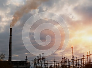 Thermal power stations and power lines during sunset.