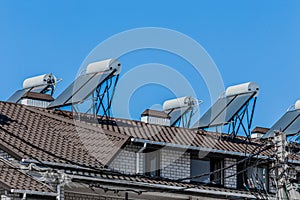 Thermal solar panels and water heater alternative technologies of water heating on the roof of the hotel against the blue sky