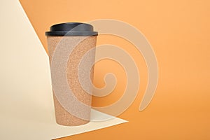 thermo mug made of cork on a beige and brown background