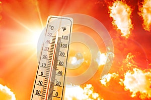 Thermometer against orange skies
