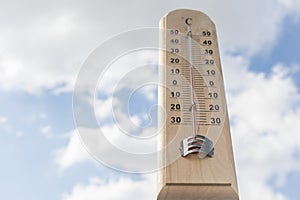 Thermometer against sky as a concept of ambient temperature