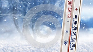 Thermometer on a background of winter forest shows 20 degrees below zero