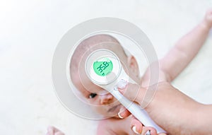 Thermometer child fever. Doctor check cold flu baby temperature care from electronic thermometer. Fever baby, child