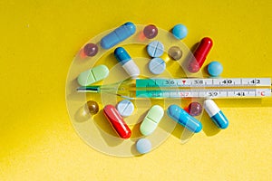 Thermometer and colored pills for treating diseases and addiction.thermometer, pharmaceutical drug , cure, colorful